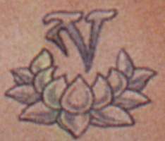 Lotus flower/Tibetan symbol tattoo